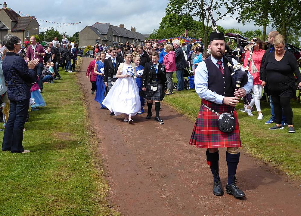 The piper leads the procession to the Crowning of the Gala Queen