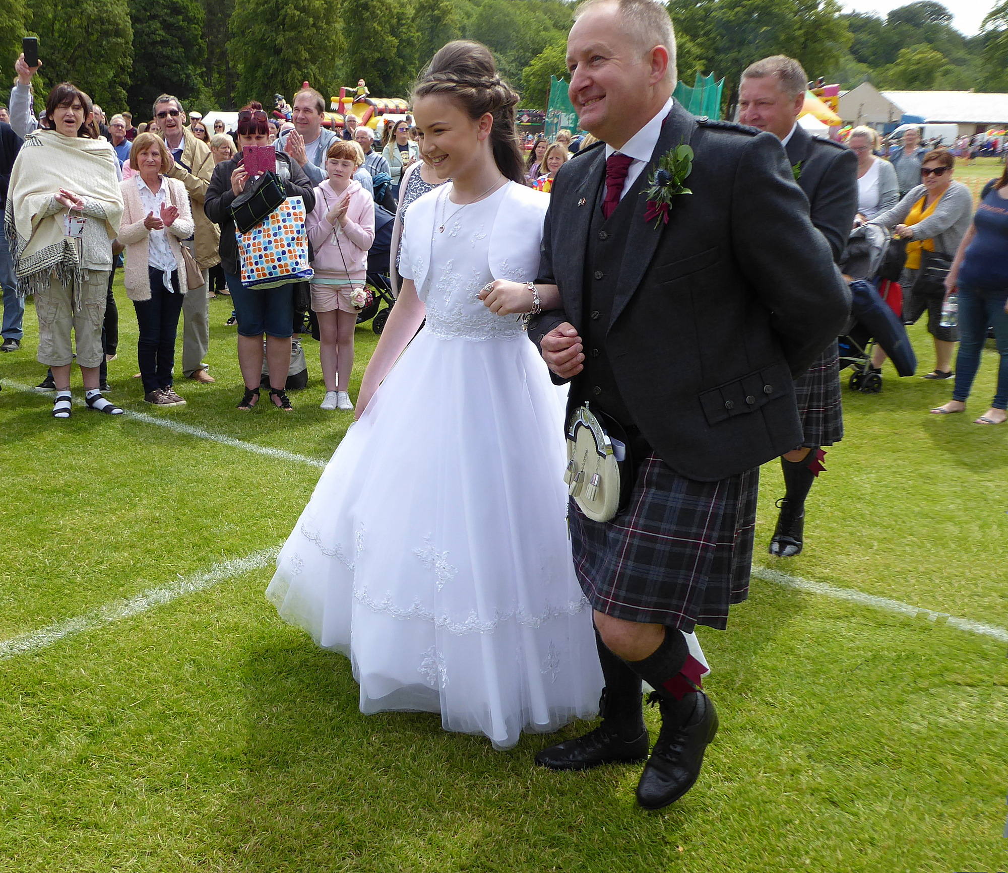 Highland Chieftain Andy Irving leads Tartan Queen Jennifer to the steps for the Coronation
