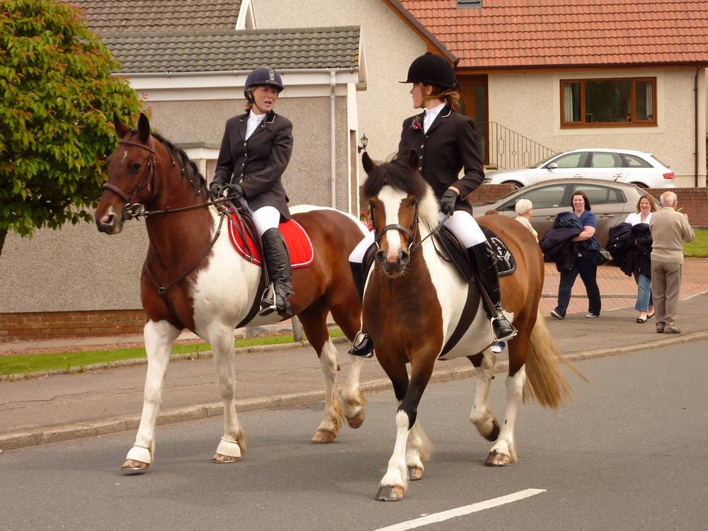 The two horses and riders leading the procession