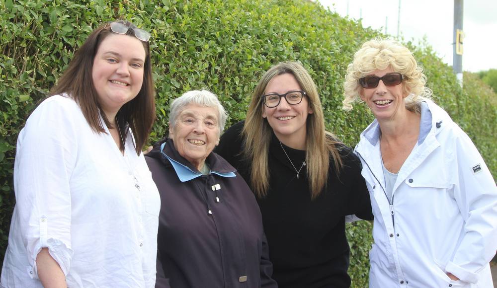 Four ladies watching procession