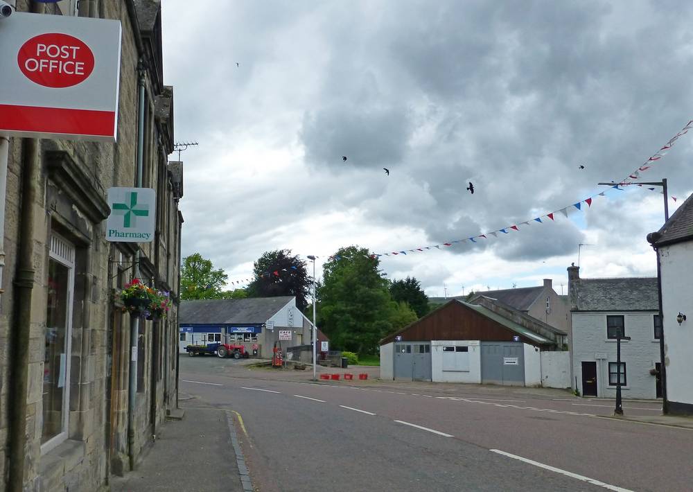 Shops in Ayr Road opposite The Douglas Arms Hotel.