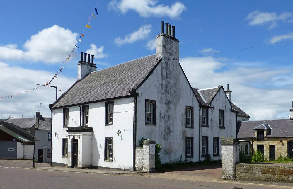 The Douglas Arms Hotel on A70 trunk road through village.