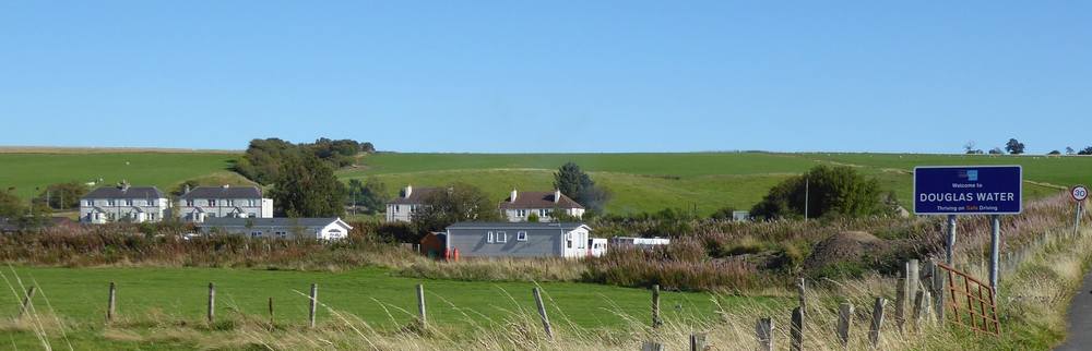 The village of Douglas Water with the Welcome sign from the North.