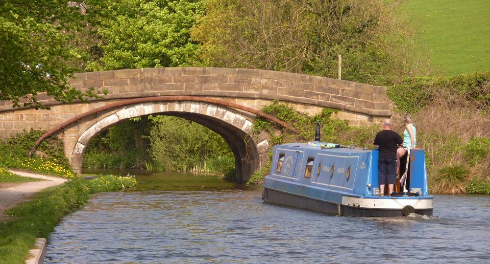 Narrow boat after crossing the Lune Aqueduct going under the bridge at Halton Road. Date of photo: 22nd April 2011.