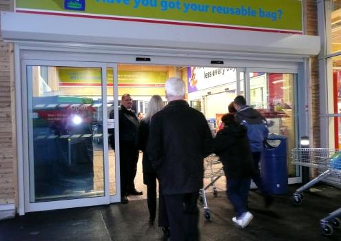 Customers entering the store at opening
